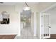 Inviting foyer with tile flooring, white columns, and an open view to the kitchen for easy entertaining at 453 Kettering Rd, Deltona, FL 32725