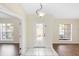 Light-filled foyer featuring a decorative glass front door, tile flooring, and views into adjacent living spaces at 453 Kettering Rd, Deltona, FL 32725