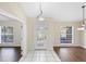 Welcoming foyer featuring a decorative glass front door, with views to the living and dining areas at 453 Kettering Rd, Deltona, FL 32725