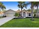 Charming single-story home with a manicured lawn, a two-car garage, and a walkway leading to the front door at 453 Kettering Rd, Deltona, FL 32725