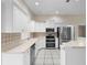 This bright, updated kitchen features stainless steel appliances, white cabinets and lots of counter space at 453 Kettering Rd, Deltona, FL 32725