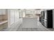 Spacious kitchen with stainless steel appliances, white cabinetry, and a breakfast bar for casual dining at 453 Kettering Rd, Deltona, FL 32725