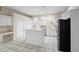 Open kitchen featuring white cabinets, stainless steel appliances, and a breakfast bar at 453 Kettering Rd, Deltona, FL 32725