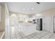 Well lit kitchen with white cabinets, a center island and stainless steel appliances at 453 Kettering Rd, Deltona, FL 32725