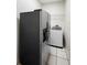 Convenient laundry area equipped with a stainless refrigerator and a washing machine at 453 Kettering Rd, Deltona, FL 32725