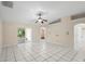 Bright living room with tile floors, ceiling fan, sliding glass doors leading to the patio, and an open layout at 453 Kettering Rd, Deltona, FL 32725