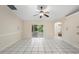 Large living room featuring tile floors and sliding doors to a screened in porch, offering ample natural light at 453 Kettering Rd, Deltona, FL 32725