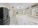 Open concept design showcasing the kitchen and living room, with tile flooring and backyard access at 453 Kettering Rd, Deltona, FL 32725