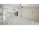 Open-concept living space with tile floors, ceiling fan, and access to kitchen area, great for entertaining at 453 Kettering Rd, Deltona, FL 32725