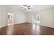 Spacious bedroom with hardwood floors, ceiling fan, access to bathroom and access to outside patio at 453 Kettering Rd, Deltona, FL 32725