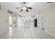 Spacious open floor plan features tile floors, ceiling fan, and flows seamlessly to the kitchen area at 453 Kettering Rd, Deltona, FL 32725