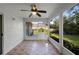 Enclosed sunroom featuring tile flooring, a ceiling fan and screened windows providing natural light at 453 Kettering Rd, Deltona, FL 32725