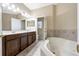 Bathroom featuring a soaking tub, double vanity, and tile floors at 484 Harbor Winds Ct, Winter Springs, FL 32708