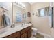 Neutral-toned powder room with a white countertop, dark wood cabinets, and flower-themed decorations at 484 Harbor Winds Ct, Winter Springs, FL 32708