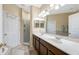 A spacious bathroom featuring double sinks, tile floors, and a glass shower at 484 Harbor Winds Ct, Winter Springs, FL 32708