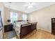 Bright bedroom with hardwood floors, a ceiling fan, and a decorative rug under the nightstand at 484 Harbor Winds Ct, Winter Springs, FL 32708