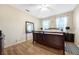 Bedroom with wood laminate flooring and neutral paint, featuring a king bed and two windows at 484 Harbor Winds Ct, Winter Springs, FL 32708