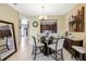 Bright dining area features a glass table, seating for four, and an open view to the kitchen at 484 Harbor Winds Ct, Winter Springs, FL 32708