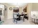 Cozy dining area featuring a round glass table, seating for four, and a view of the kitchen at 484 Harbor Winds Ct, Winter Springs, FL 32708