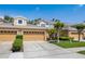 Inviting exterior view showcasing a row of townhomes with well-maintained landscaping and two-car garages at 484 Harbor Winds Ct, Winter Springs, FL 32708