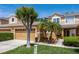 A beautifully landscaped townhome featuring a two-car garage, mature trees, and a well-manicured lawn at 484 Harbor Winds Ct, Winter Springs, FL 32708
