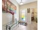 Bright foyer with decorative glass door, tile flooring, console table and artwork at 484 Harbor Winds Ct, Winter Springs, FL 32708