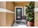 Cozy front porch featuring a comfortable chair, potted plants, and a decorative front door at 484 Harbor Winds Ct, Winter Springs, FL 32708