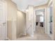 Bright hallway leading to carpeted stairs and bedroom with ensuite bathroom at 484 Harbor Winds Ct, Winter Springs, FL 32708