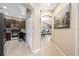 Hallway leading to kitchen and living room with neutral walls and tile flooring at 484 Harbor Winds Ct, Winter Springs, FL 32708