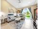 Cozy living room featuring comfortable sofas, stylish decor, and a sliding glass door leading outdoors at 484 Harbor Winds Ct, Winter Springs, FL 32708