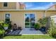 Back patio with sliding glass door and landscaping at 484 Harbor Winds Ct, Winter Springs, FL 32708