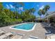 Community pool area featuring lounge chairs, blue water, and palm trees under a blue sky with white clouds at 484 Harbor Winds Ct, Winter Springs, FL 32708