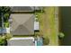 Aerial view of property showcasing backyard, lush lawn, lake, and landscaping at 5112 Jetsail Dr, Orlando, FL 32812