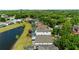 Aerial view of a home with a lake view and green surroundings in a residential area at 5112 Jetsail Dr, Orlando, FL 32812