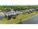 Aerial view showcases a home with screened-in pool, lush greenery, and waterfront at 5112 Jetsail Dr, Orlando, FL 32812