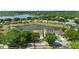 Scenic aerial view of a property with lake access and mature trees in a neighborhood at 5112 Jetsail Dr, Orlando, FL 32812