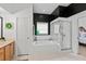 Bathroom with tub and separate glass shower, single vanity, and contrasting black and white walls at 5112 Jetsail Dr, Orlando, FL 32812