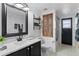 Bathroom with contrasting black and white vanity and trim, standing shower and bathtub at 5112 Jetsail Dr, Orlando, FL 32812