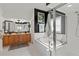 Bright bathroom with separate tub and glass shower, double vanity, and contrasting walls at 5112 Jetsail Dr, Orlando, FL 32812