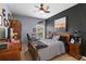 Inviting bedroom with ceiling fan, wooden furniture, and decorative elements at 5112 Jetsail Dr, Orlando, FL 32812