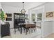 Elegant dining area featuring a modern light fixture, stylish furnishings, and bright natural light at 5112 Jetsail Dr, Orlando, FL 32812