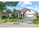 Inviting single-Gathering home with a manicured lawn and tropical landscaping creating an inviting curb appeal at 5112 Jetsail Dr, Orlando, FL 32812
