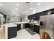 Bright, modern kitchen with stainless steel appliances, black cabinetry, and a breakfast bar at 5112 Jetsail Dr, Orlando, FL 32812