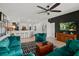 Open-concept living room with tufted sofas, modern decor, and a view into the kitchen at 5112 Jetsail Dr, Orlando, FL 32812