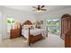 Main bedroom with wood furniture, neutral décor, and sliding glass doors overlooking beautiful lake view at 5112 Jetsail Dr, Orlando, FL 32812