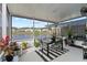 Enclosed patio with a lake view, dining set, and stylish decor at 5112 Jetsail Dr, Orlando, FL 32812