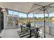 Outdoor patio features a dining table, umbrella, and screen, with a view of the beautiful lake at 5112 Jetsail Dr, Orlando, FL 32812