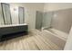 Bathroom featuring a double vanity, tub, and shower at 5999 Lake Pointe Dr # 602, Orlando, FL 32822