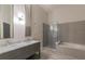A luxurious bathroom featuring a dual sink vanity, a modern glass shower, and a relaxing soaking tub at 5999 Lake Pointe Dr # 602, Orlando, FL 32822