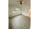 Bright bedroom featuring a large arched window, ceiling fan, and two closets, perfect for relaxation and storage at 5999 Lake Pointe Dr # 602, Orlando, FL 32822